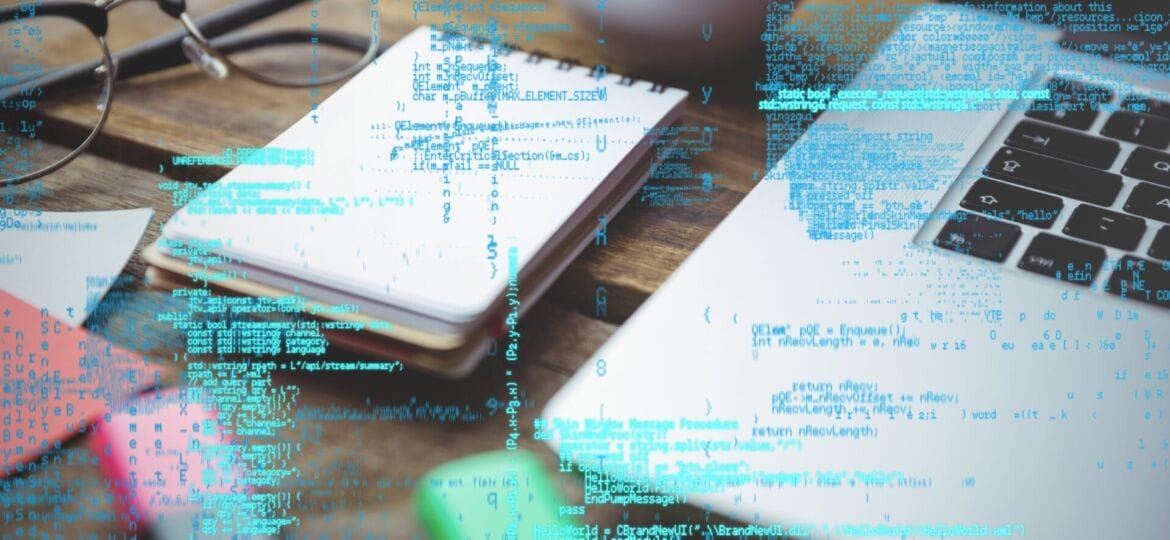 digital composite of laptop with notepad and coffee on table with graphics
