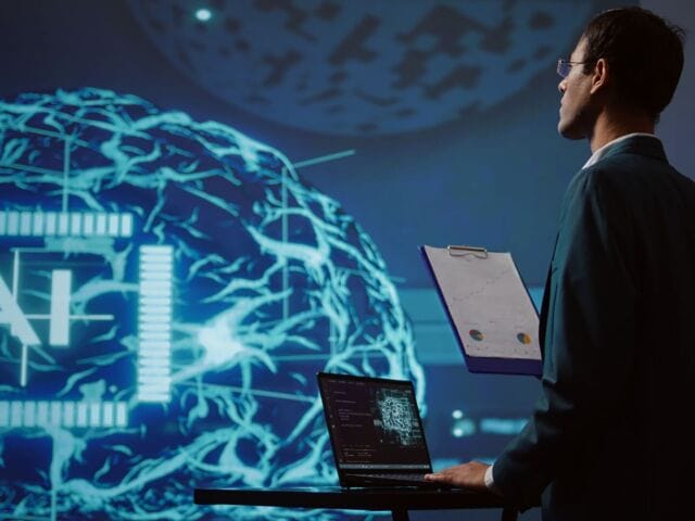 Startup employee looking over business charts using AI software
