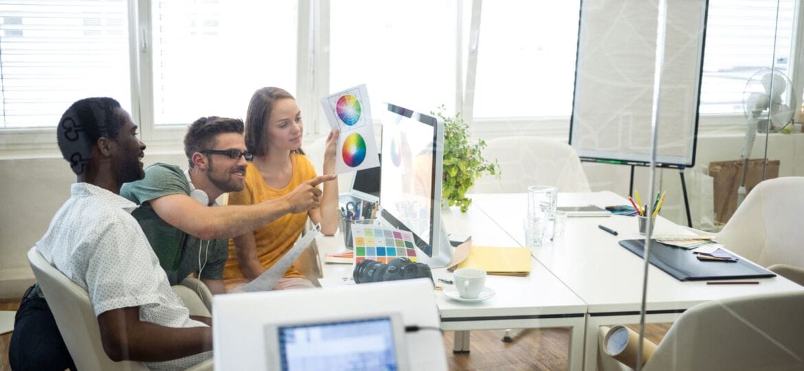Group of graphic designers working on computer