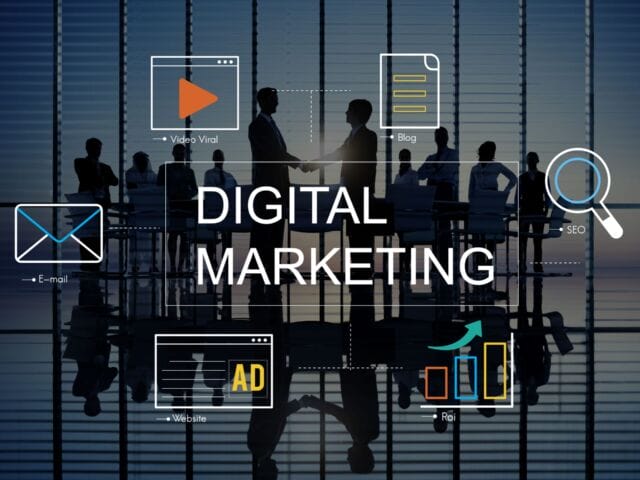 A sign in front of a glass-door office reads "Digital Marketing" as decoration for our post about online marketing consultant experts.