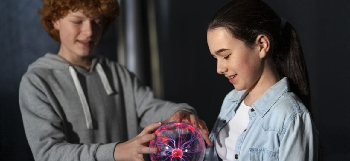 medium-shot-kids-interacting-with-plasma-ball