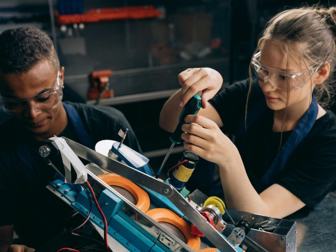 Two employees work on a manufacturing project. (Photo by: Mikhail Nilov).