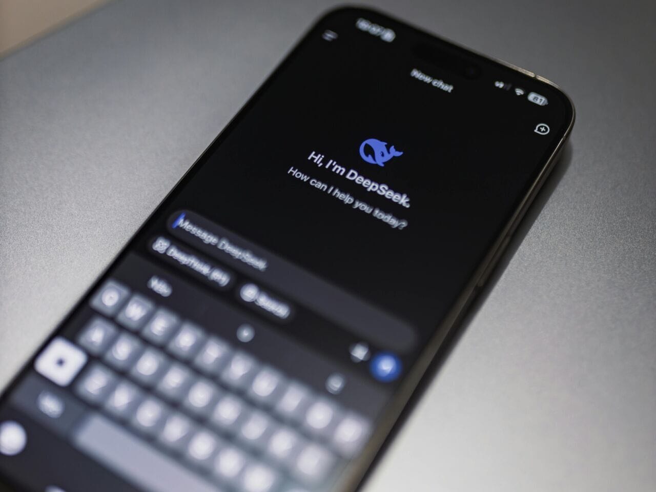 A phone displays an AI conversational app called "DeepSeek/"
